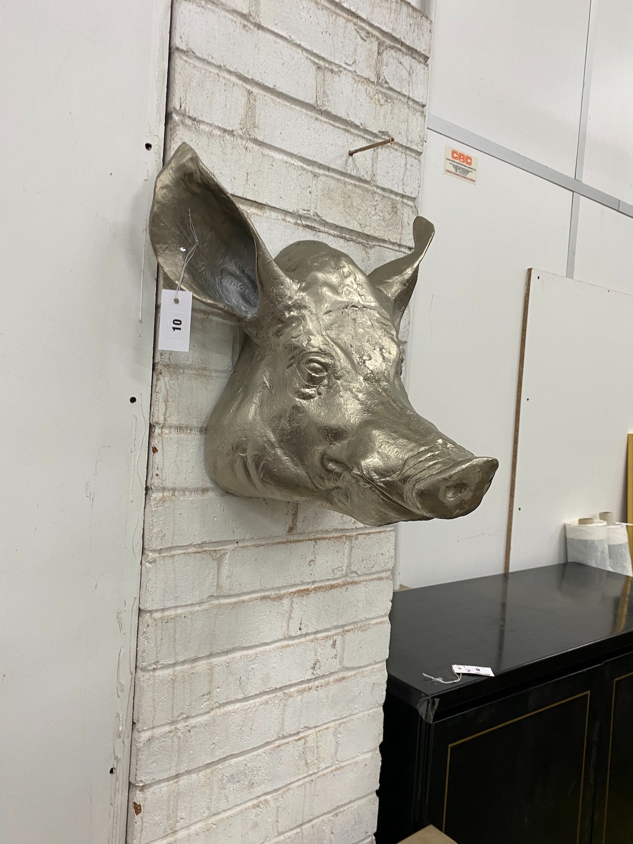 A cast metal wall mounted pigs head ornament, height 44cm